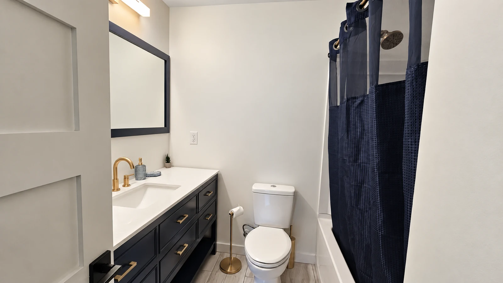 Upstairs hall bathroom showing the vanity, toilet and shower curtain